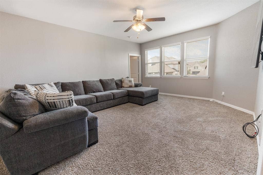 3605 Barby Court, Midlothian, TX 76065 Carpeted room with a ceiling fan, three windows with blinds, and white trim