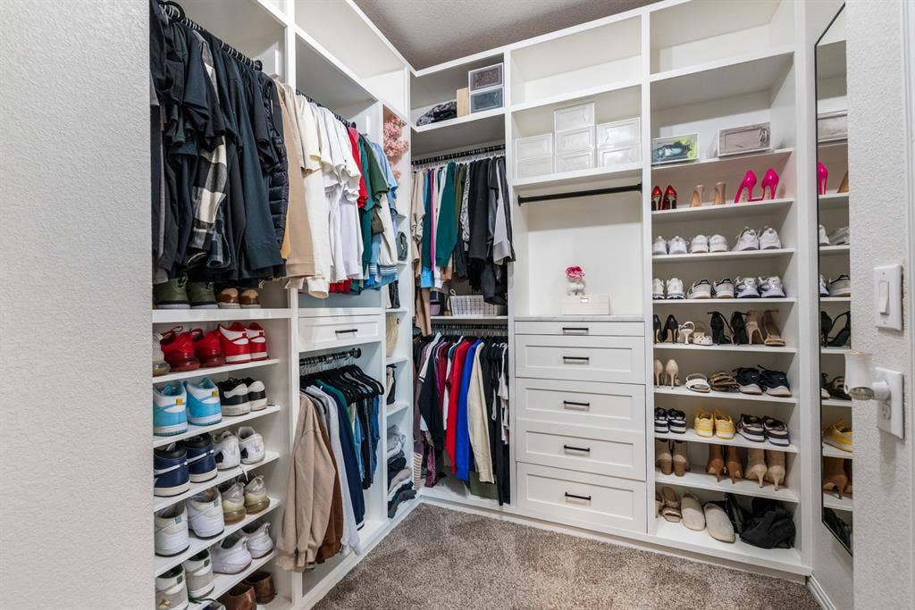3605 Barby Court, Midlothian, TX 76065 Built-in white custom closet system featuring multiple hanging rods, shelving, and drawer storage