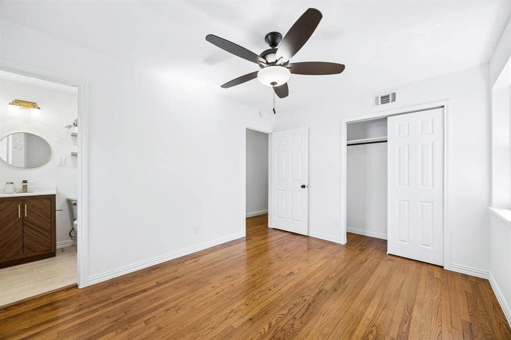 Large deep closet in this primary suite. Love the original floors that remind you of the beauty and quality of construction during  this era