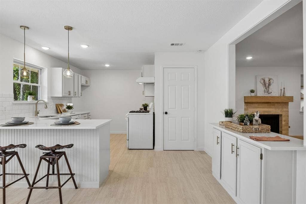 Coffee bar with additional storage or dry bar for easy flow entertainment .   I love how this space is open to the living room and yet still maintains the charm of home