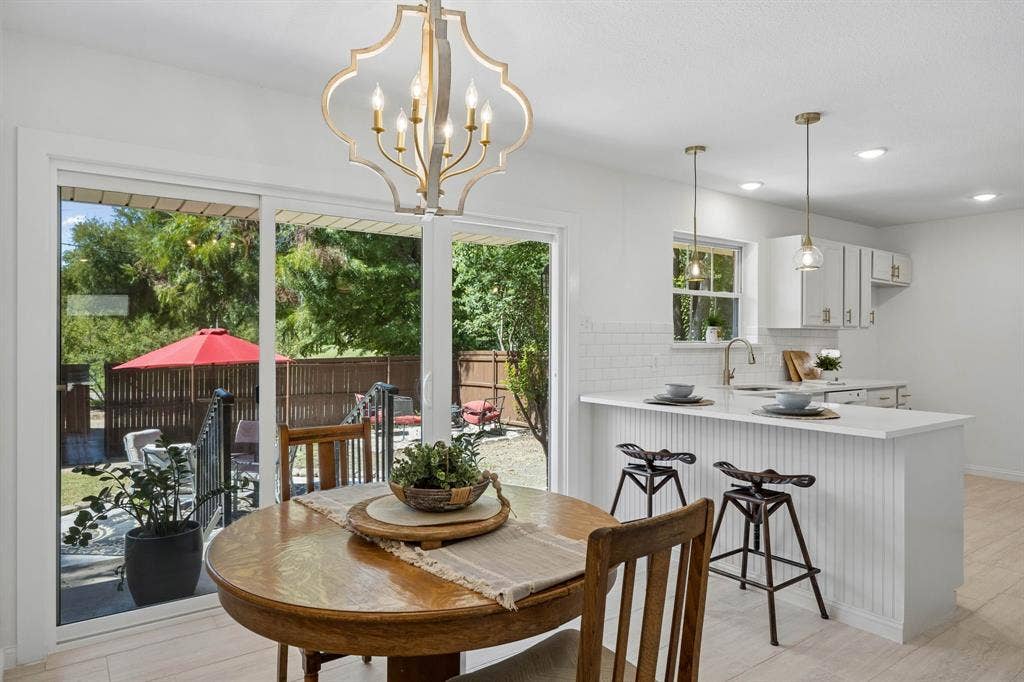 Open kitchen with new cabinets, countertops lighting and more.