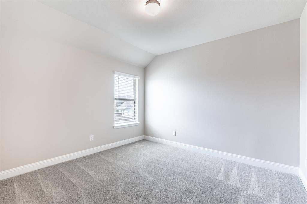 405 Rosie Court, Argyle, TX 76226 Spacious upstairs bedroom, three of three bedrooms on the second floor, featuring generous living space, natural light, and an oversized walk-in closet.