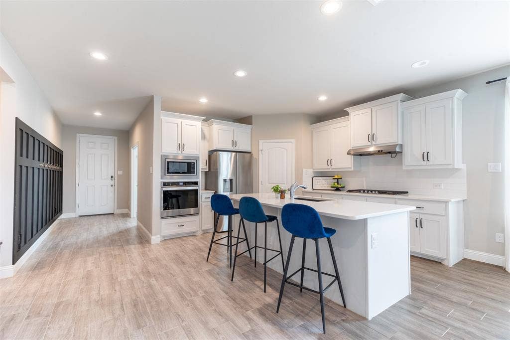 405 Rosie Court, Argyle, TX 76226 Spacious kitchen with a large, open layout flowing seamlessly from the entryway, creating an inviting sense of space and easy everyday living.