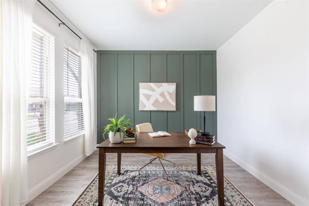 405 Rosie Court, Argyle, TX 76226 Spacious home office with large windows providing abundant natural light, complemented by a board-and-batten accent wall that adds character and timeless style.