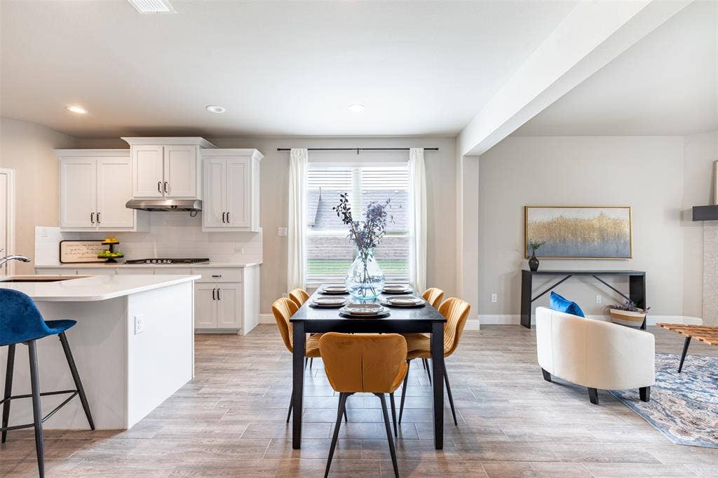 405 Rosie Court, Argyle, TX 76226 Spacious eat-in kitchen with ample room for a large dining table, creating an inviting gathering space for family meals and entertaining.