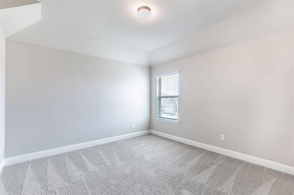 405 Rosie Court, Argyle, TX 76226 Spacious upstairs bedroom, two of three bedrooms on the second floor, featuring generous living space, natural light, and an oversized walk-in closet.