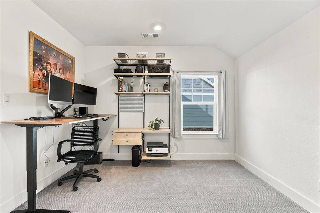 Neutral-toned carpet, recessed lighting, and a single-hung window featuring a grid pattern