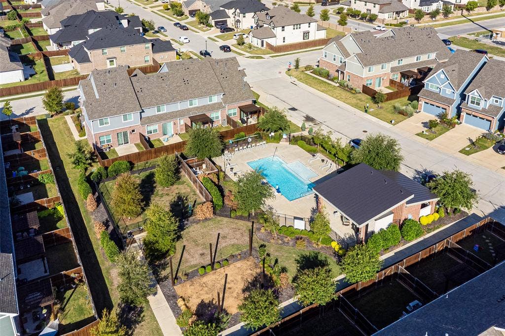Community swimming pool, fenced perimeter, concrete pool decking, clubhouse, and paved pedestrian walkways