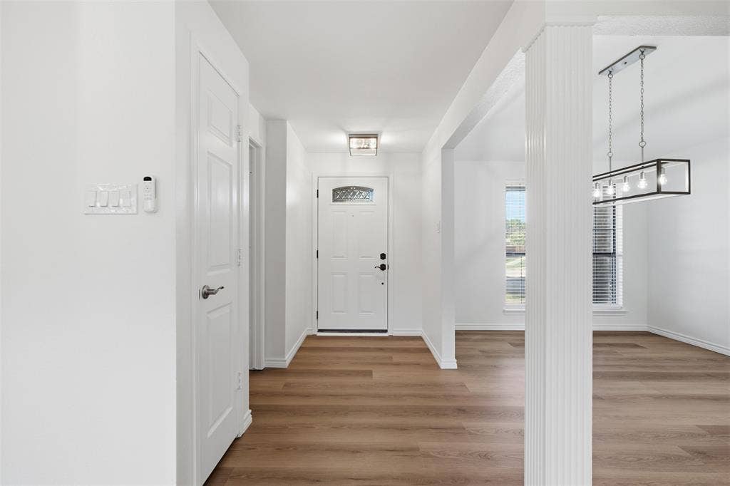 661 Thompson Drive, Coppell, TX 75019 Wood-finish flooring throughout, white interior doors, and a decorative front entry door with a clear glass insert