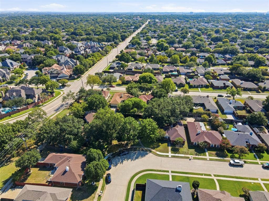 661 Thompson Drive, Coppell, TX 75019 Aerial perspective of this established residential community featuring tree-lined streets, spacious corner lot positioning, and mature landscaping throughout the neighborhood
