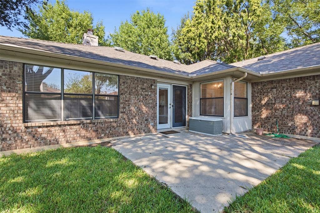 661 Thompson Drive, Coppell, TX 75019 Brick exterior construction with an expansive concrete patio and large windows