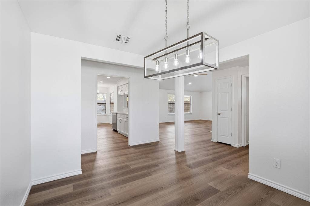 661 Thompson Drive, Coppell, TX 75019 Wood-finish flooring throughout, with a linear chandelier, recessed lighting, and white interior doors