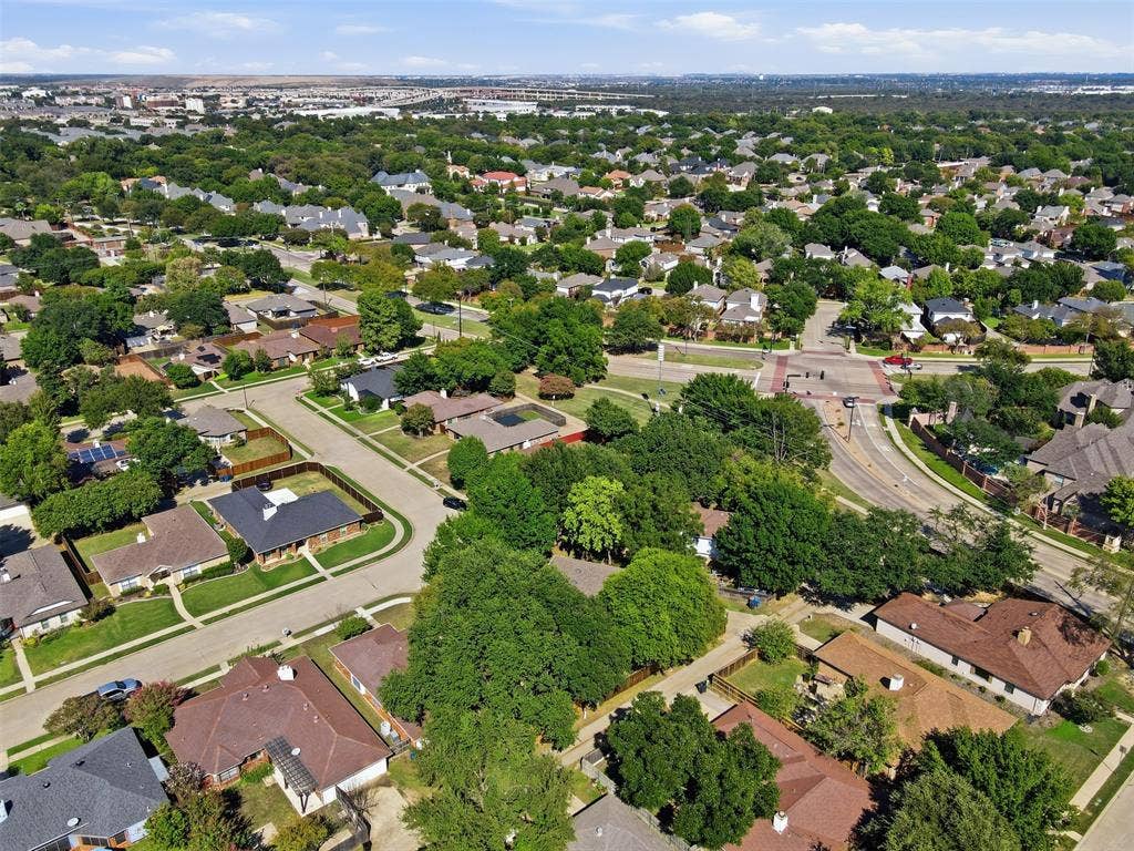 661 Thompson Drive, Coppell, TX 75019 Established residential neighborhood featuring tree-lined streets, single-family homes with varied architectural styles, and mature landscaping throughout the community