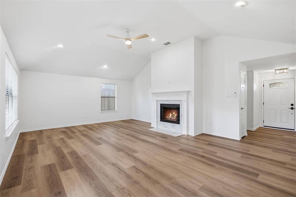 661 Thompson Drive, Coppell, TX 75019 Vaulted ceiling, wood-finish flooring, recessed lighting, ceiling fan, and a fireplace with a mantel
