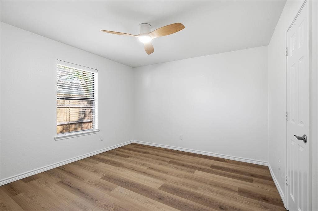 661 Thompson Drive, Coppell, TX 75019 Wood-finish flooring, white painted walls, and a ceiling fan with light fixture