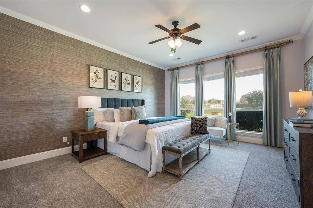 Textured wall covering, three large windows, recessed ceiling lighting, and a ceiling fan with integrated light fixture