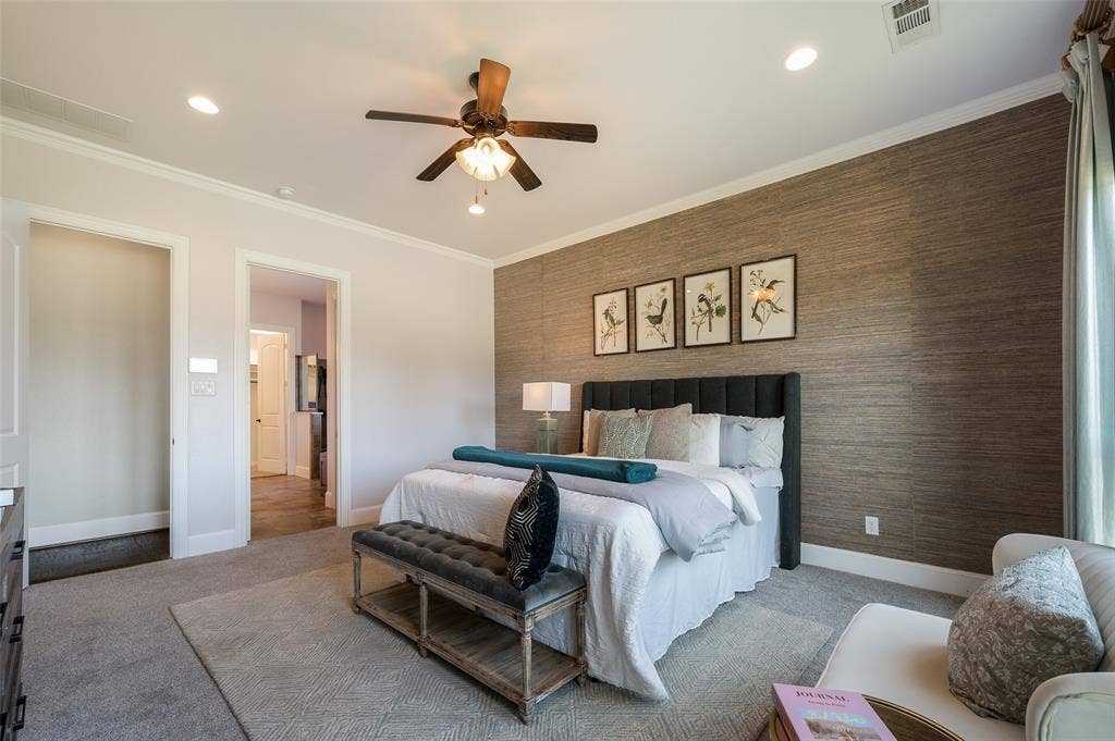 Bedroom featuring a textural, grasscloth-style accent wall, recessed lighting, and a multi-blade ceiling fan with integrated light fixture