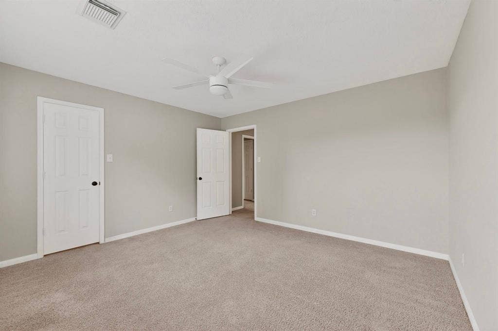 Neutral-toned walls complement plush carpeting