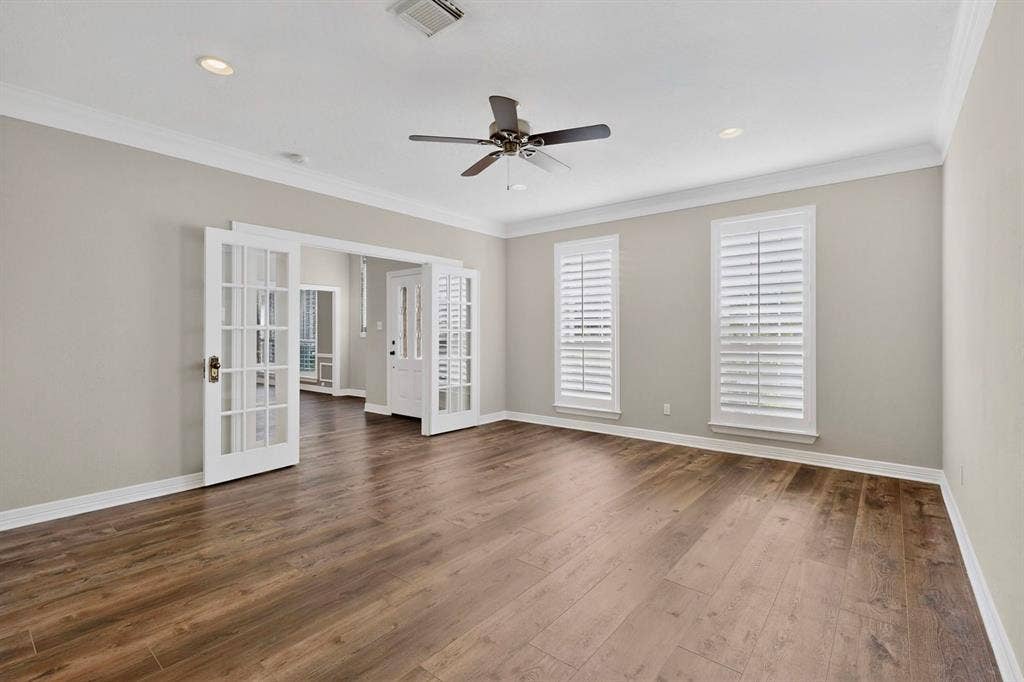 Wood-finish flooring throughout, recessed lighting, and crown molding