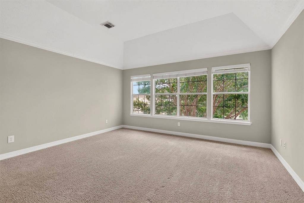 Tray ceiling accentuates the spacious room with neutral wall tones and plush carpet flooring