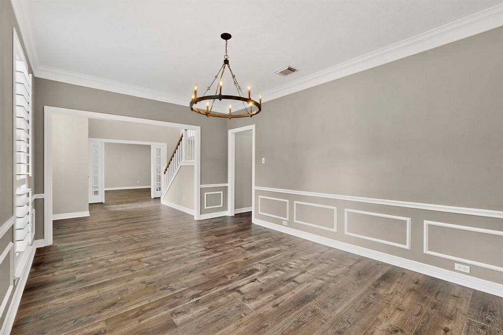 Wood-finish flooring throughout, complemented by crown molding and wainscoting