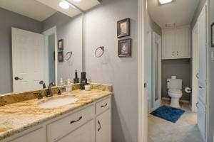 5212 Mustang Trail, Plano, TX 75093 Vanity with a granite countertop, undermount sink, and dark bronze fixtures