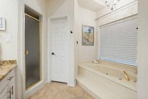 5212 Mustang Trail, Plano, TX 75093 Built-in soaking tub with deck surround, gold-finish fixtures, and window with privacy blinds