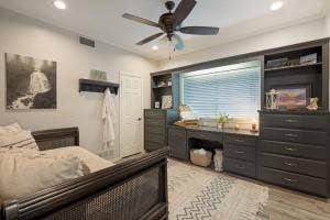 5212 Mustang Trail, Plano, TX 75093 Built-in desk and storage cabinetry, recessed lighting, ceiling fan, window with blinds, and wood-finish flooring