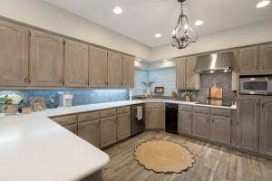 5212 Mustang Trail, Plano, TX 75093 Spacious kitchen featuring light-toned cabinetry, light-colored countertops, stainless steel appliances, and wood-look flooring