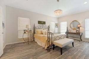 5212 Mustang Trail, Plano, TX 75093 Wood-finish flooring throughout, light neutral wall tones, and multiple windows with blinds