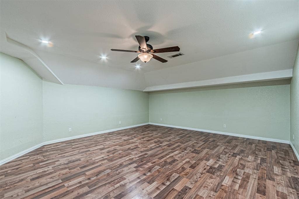8808 Sylvan Court, Fort Worth, TX 76120 Wood-finish flooring with light green walls, recessed lighting, and a ceiling fan