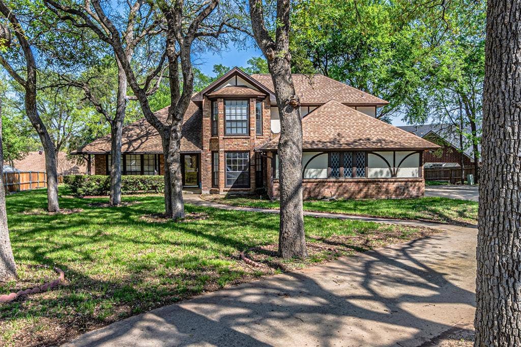8808 Sylvan Court, Fort Worth, TX 76120 Brick and siding exterior with multiple gables and a prominent bay window