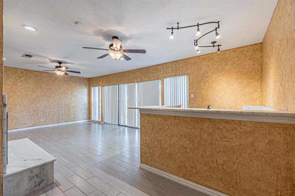 8808 Sylvan Court, Fort Worth, TX 76120 Wood-finish flooring throughout, two ceiling fans with integrated lighting, recessed lighting, and track lighting