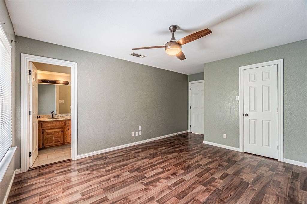 8808 Sylvan Court, Fort Worth, TX 76120 Wood-finish flooring with a ceiling fan with light fixture