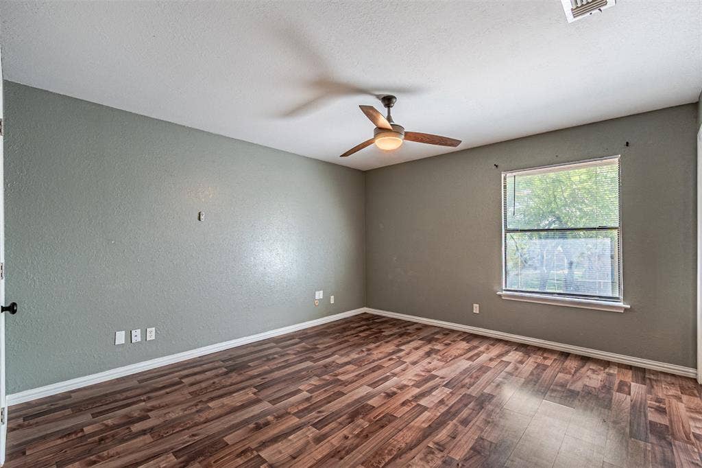 8808 Sylvan Court, Fort Worth, TX 76120 Wood-finish flooring, single window, ceiling fan, and painted walls