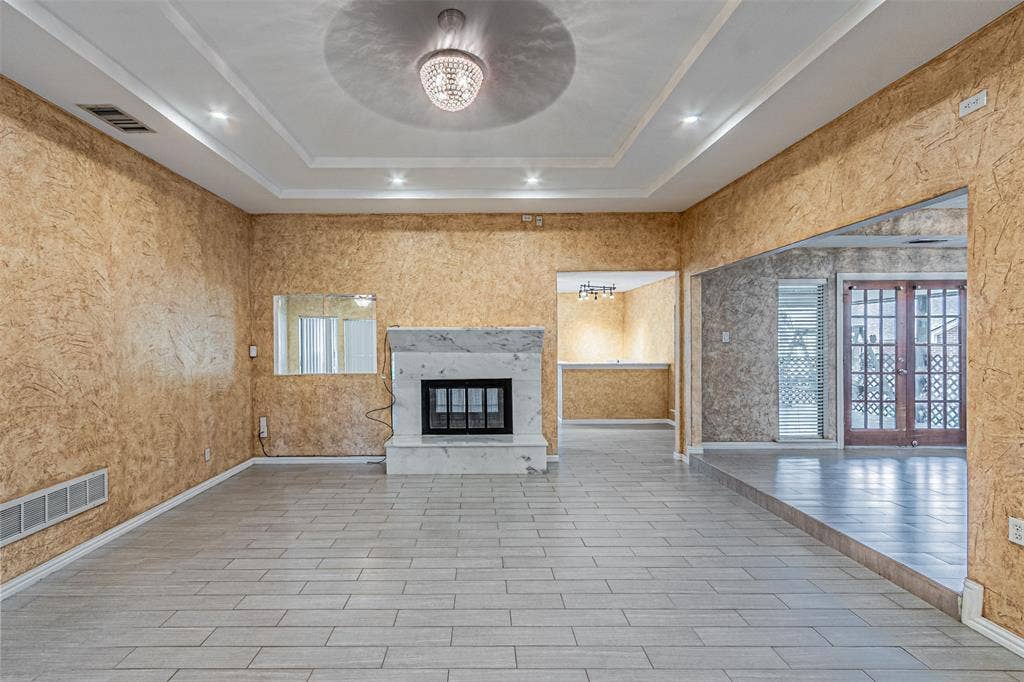 8808 Sylvan Court, Fort Worth, TX 76120 Tray ceiling with recessed lighting and a central chandelier