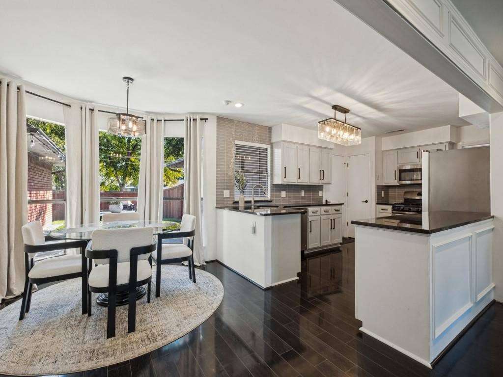 5730 Winding Woods Trail, Dallas, TX 75227 Kitchen featuring wood-finish flooring, shaker-style cabinetry, a peninsula with stone-surface countertops, and rectangular tile backsplash