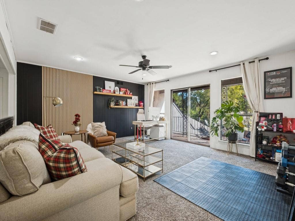 5730 Winding Woods Trail, Dallas, TX 75227 Living area featuring wood-slat accent wall, recessed lighting, ceiling fan, and sliding glass doors with exterior access