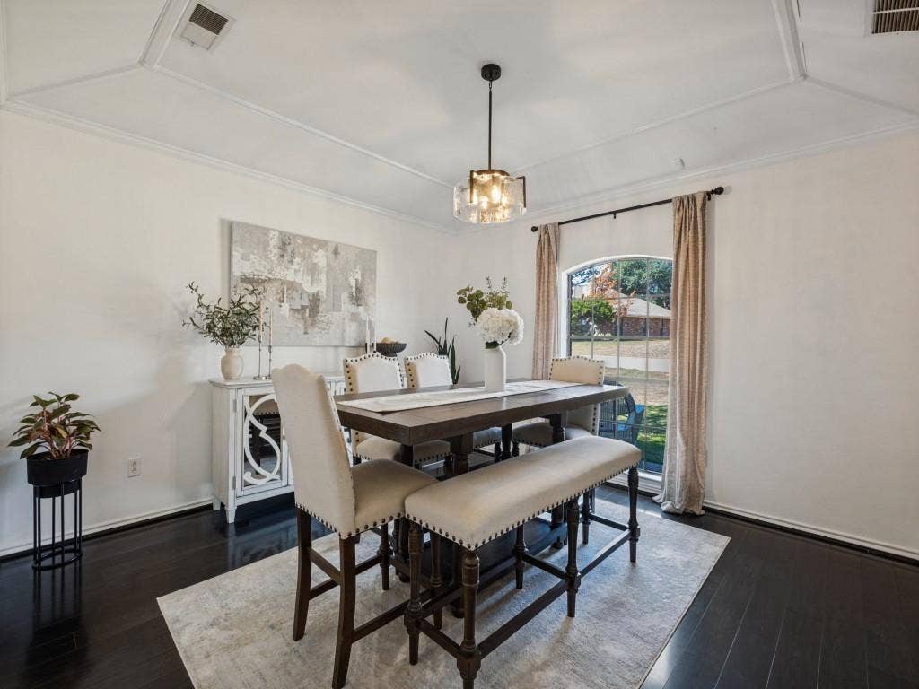 5730 Winding Woods Trail, Dallas, TX 75227 Tray ceiling, dark wood-finish flooring, and arched window with a metal-framed pendant light fixture