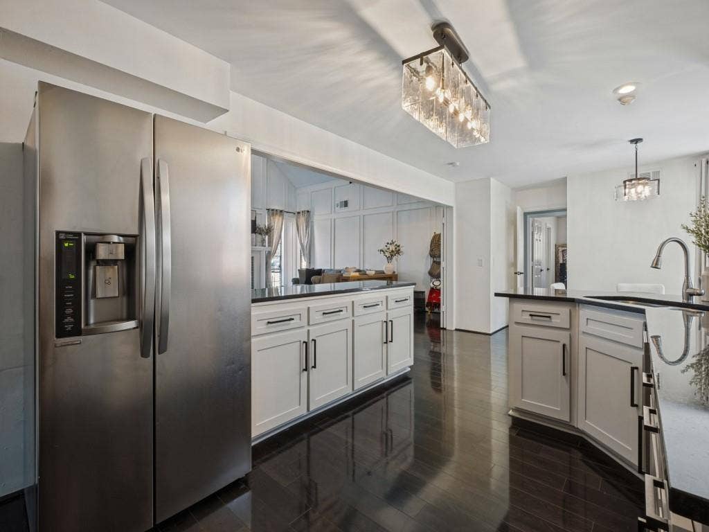 5730 Winding Woods Trail, Dallas, TX 75227 Kitchen featuring white shaker-style cabinetry with matte black hardware, dark stone countertops, stainless steel side-by-side refrigerator, recessed lighting, and wood-finish flooring