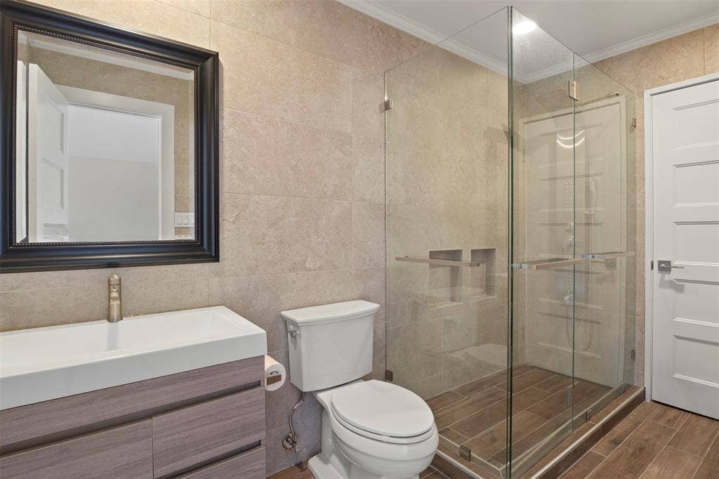 Frameless glass shower enclosure with built-in niches