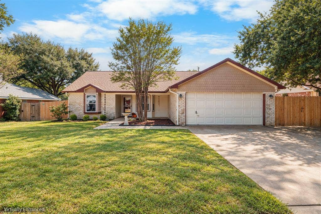 10712 Apache Drive, Waco, TX 76712 Brick exterior with a shingle roof and a two-car garage