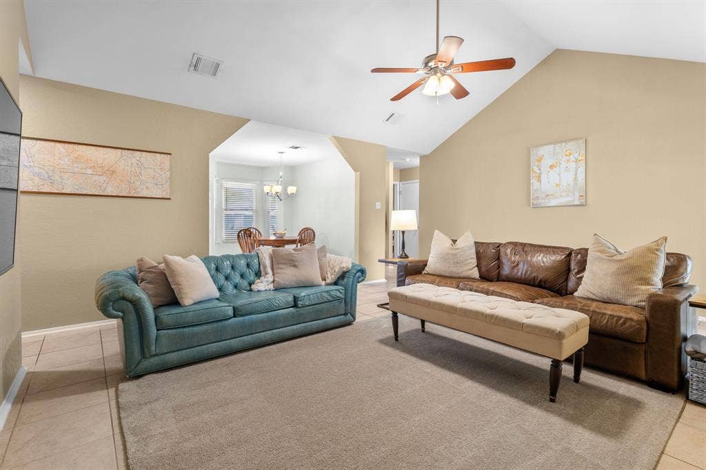 10712 Apache Drive, Waco, TX 76712 Vaulted ceiling with a ceiling fan, tile flooring, and an arched doorway