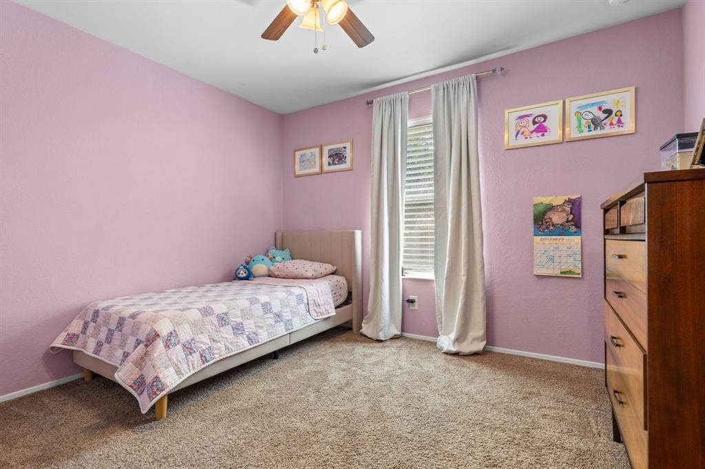 10712 Apache Drive, Waco, TX 76712 Wall-to-wall carpeting, ceiling fan with integrated lighting, and window with blinds and drapes