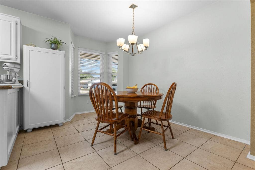 10712 Apache Drive, Waco, TX 76712 Light-toned tile flooring, bay window with blinds, and recessed lighting