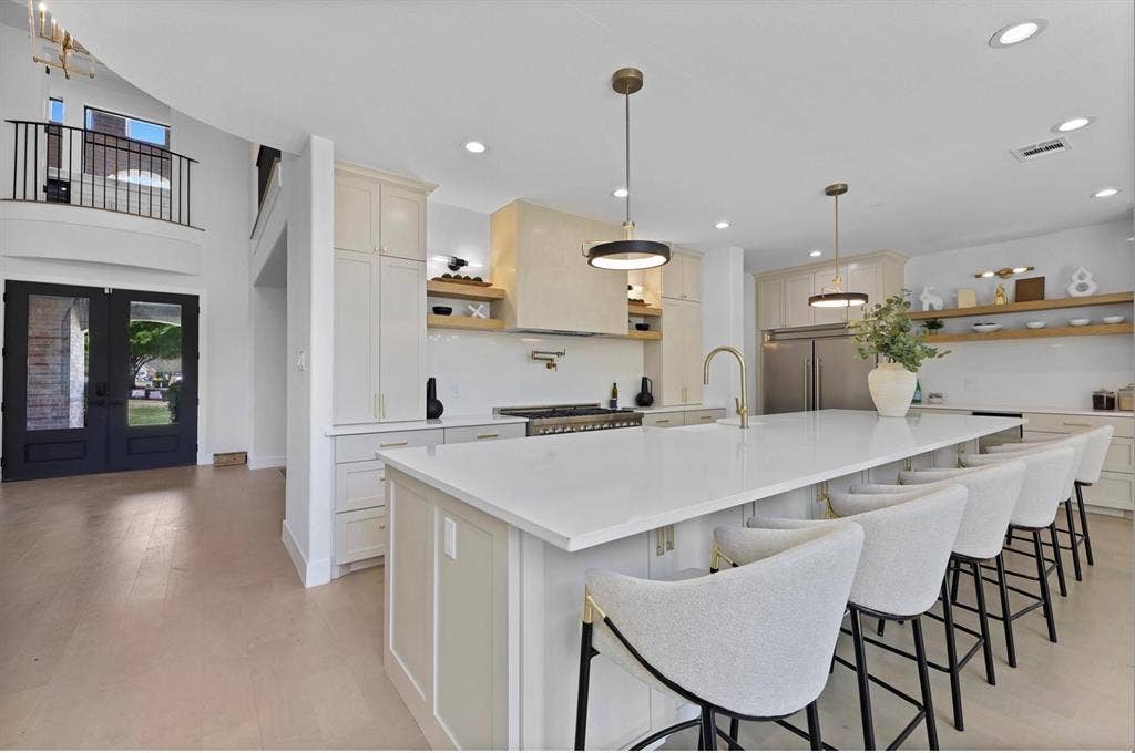 1750 Greenwood Court, Prosper, TX 75078 Spacious kitchen with a large central island, integrated appliances, and open shelving
