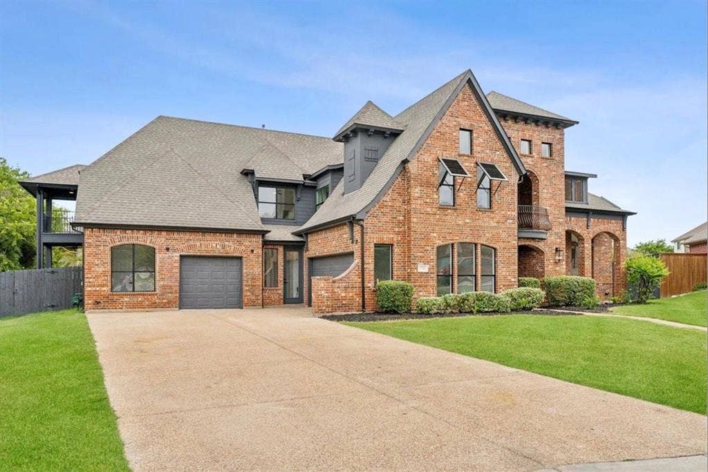 1750 Greenwood Court, Prosper, TX 75078 Brick exterior with multiple architectural elements, a two-car garage, and a concrete driveway