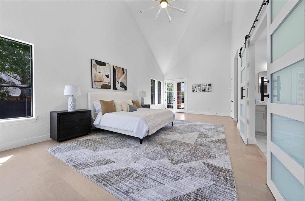 1750 Greenwood Court, Prosper, TX 75078 Vaulted ceiling with a ceiling fan, light wood-finish flooring, and double French doors