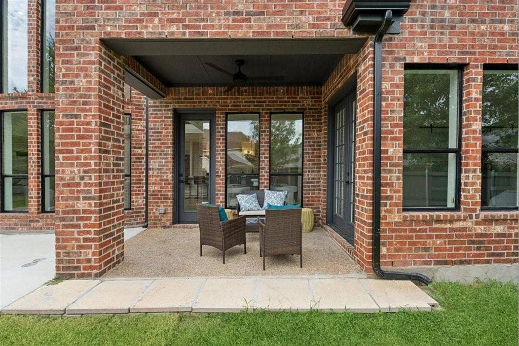 1750 Greenwood Court, Prosper, TX 75078 Covered outdoor patio with a ceiling fan, brick exterior, and multiple large windows