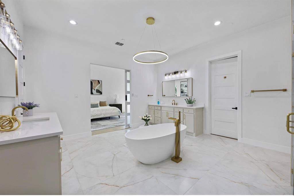 1750 Greenwood Court, Prosper, TX 75078 Freestanding soaking tub with gold-finish floor-mounted filler